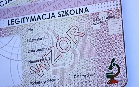 Fragment legitymacji szkolnej z napisem "WZÓR" i mikroskopem.